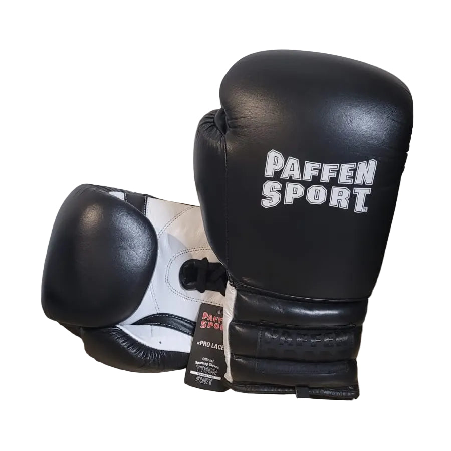 Black boxing gloves with 'PAFFEN SPORT' branding on a wooden surface.