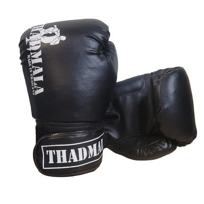 Black boxing gloves with 'THADMA' branding on a wooden surface.