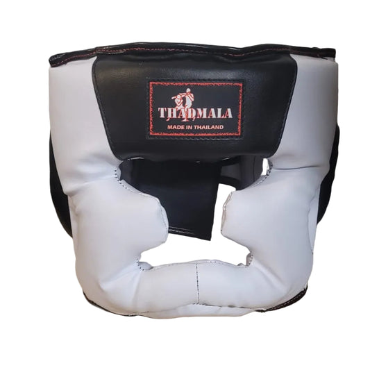 White and black boxing headgear with a brand logo on a wooden surface.