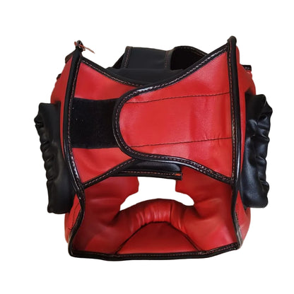 Red and black boxing headgear on a wooden surface