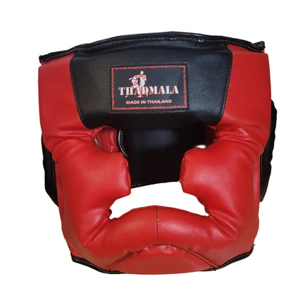 Red and black boxing headgear with a brand logo on a wooden surface.
