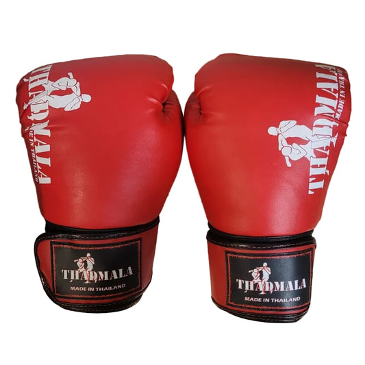 Red boxing gloves with 'Thailand' branding on a wooden surface.