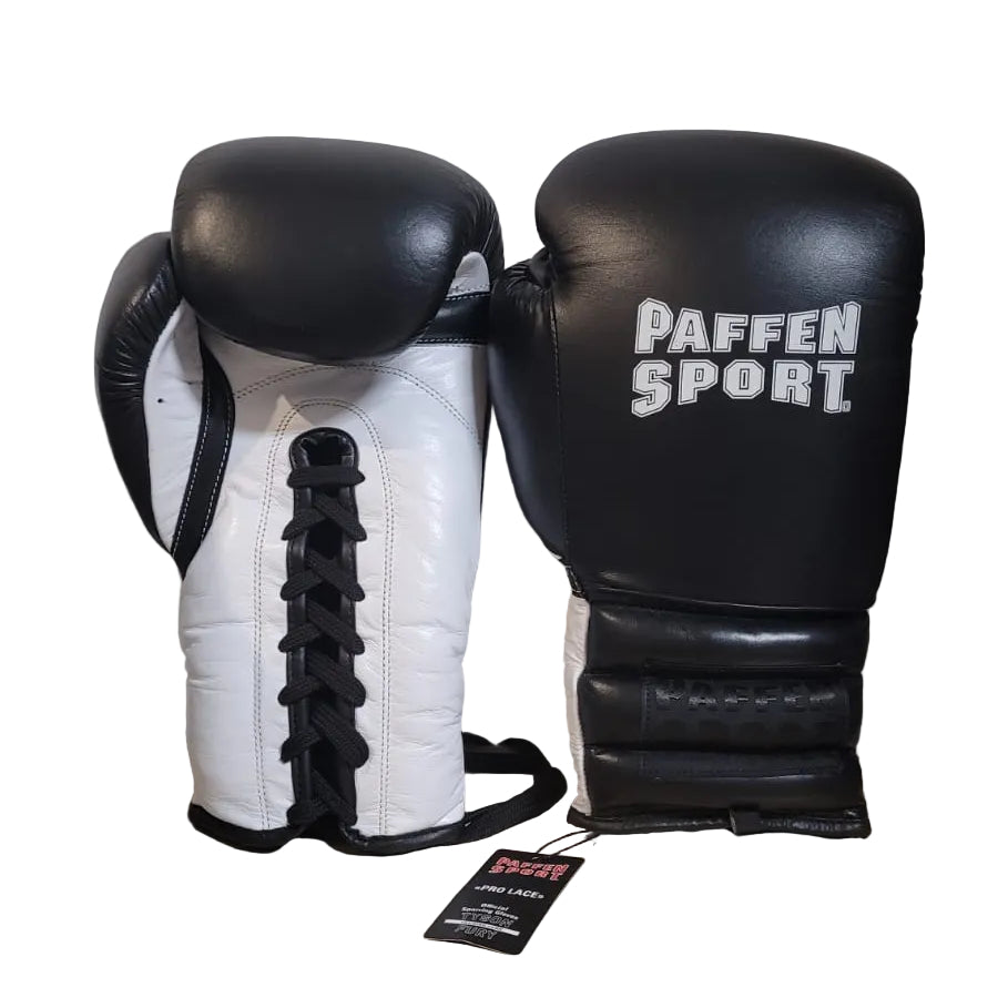 Pair of black and white boxing gloves with 'Paffen Sport' branding on a wooden surface.
