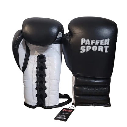 Pair of black and white boxing gloves with 'Paffen Sport' branding on a wooden surface.