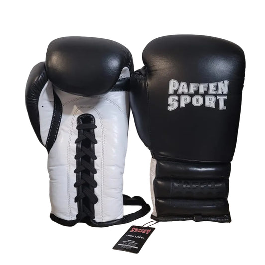 Pair of black and white boxing gloves with 'Paffen Sport' branding on a wooden surface.