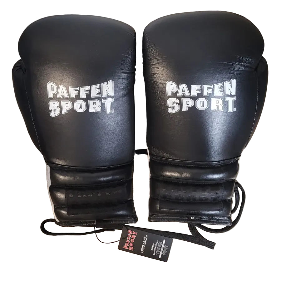 Black boxing gloves with 'PAFFEN SPORT' branding on a wooden surface.